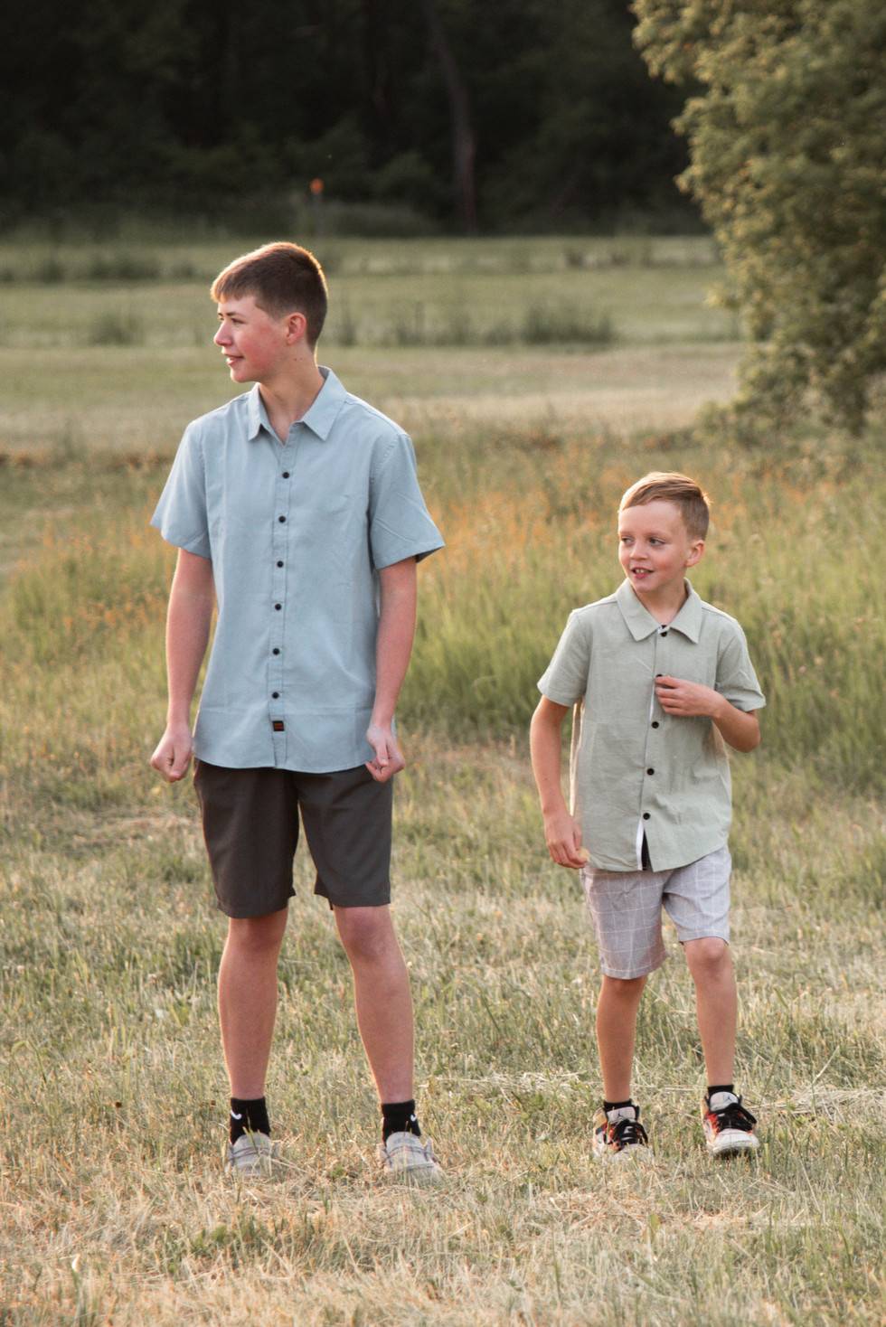 two brothers smiling and walking in large field during sunset ice age trail lodi wisconsin