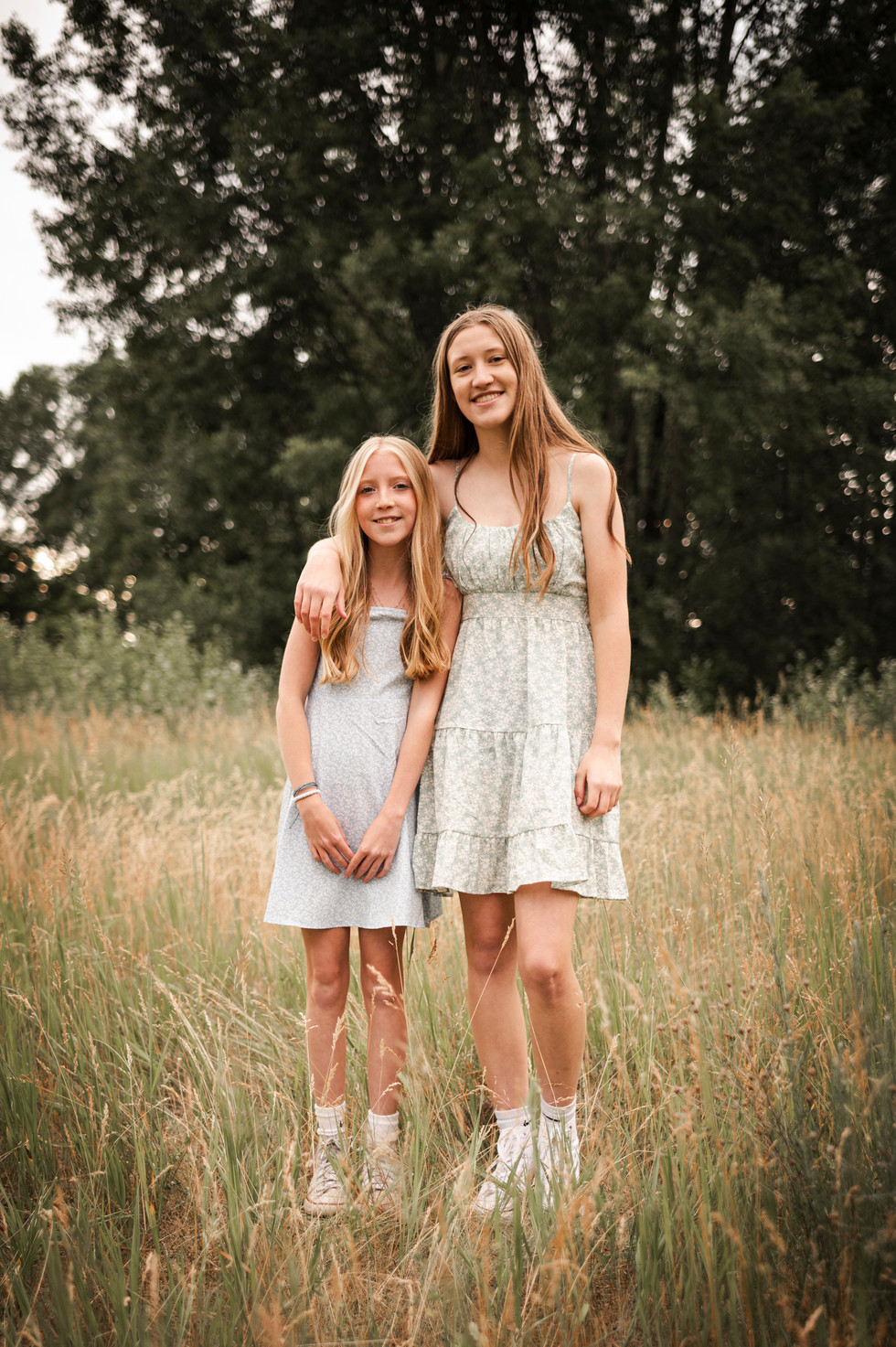 two teenage sister smiling in field ice age trail lodi wisconsin