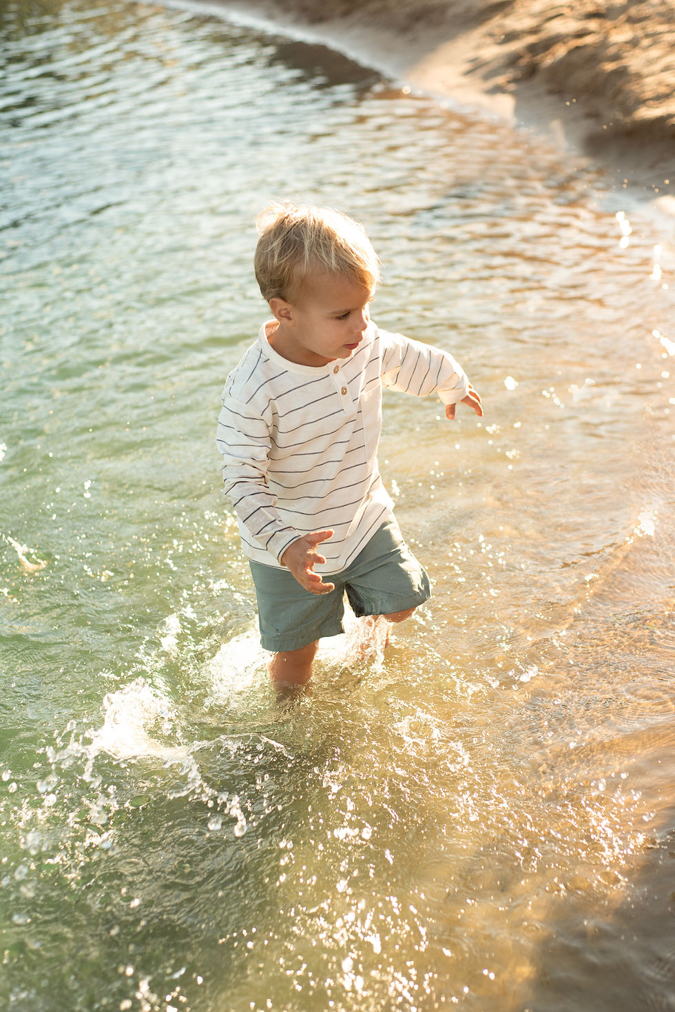 small blonde boy playing in water in Wisconsin Dells Wisconsin