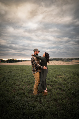 man and woman slow dancing with a large field and sunset behind them in Stoughton Wisconsin