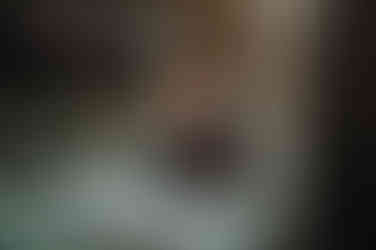 man sitting on patio smoking a cigar and looking at phone at Whispering Pines Event Center in Poynette Wisconsin