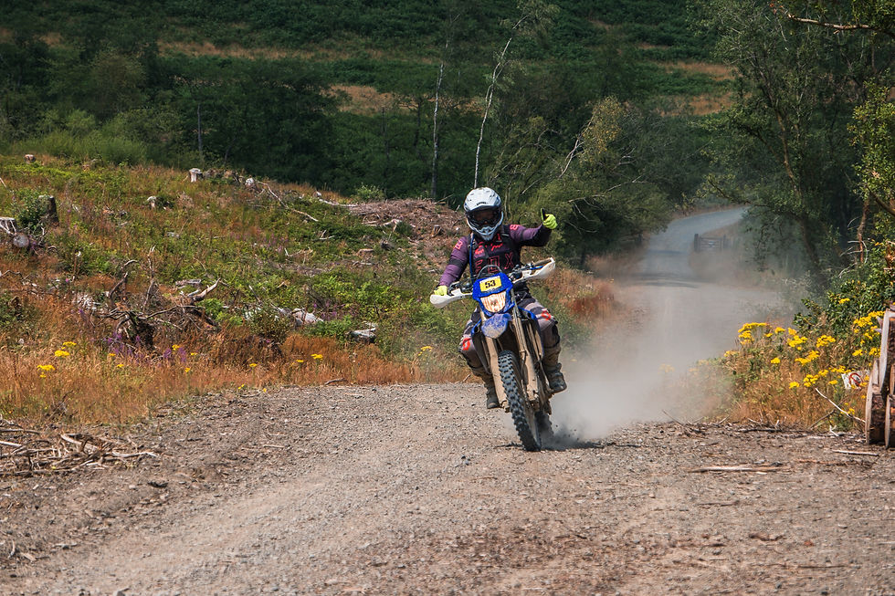 Sarah Taylor tackling the rugged terrain during the R2 Clubman class of the Beacons Rally 2026, kicking up dust on a scenic forest road.