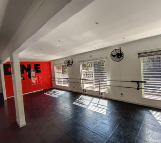 Dance studio hire featuring fitted double ballet barres, cooling fans, and large windows