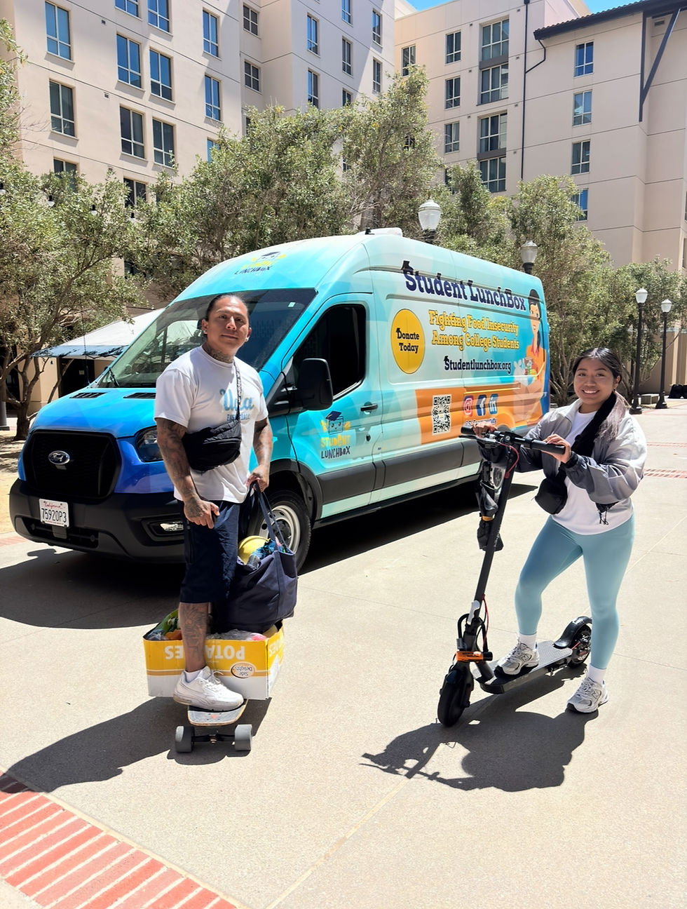 Two students with skateboards and an e-scooter stand in front of the Student LunchBox van, which is dedicated to addressing food insecurity among college students.