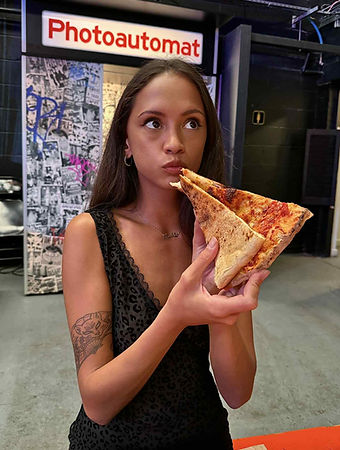 Woman Holding Huge Slice of Pizza