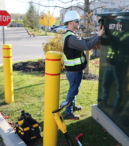 Utility locator using EM equipment to trace underground service lines near a pad-mounted transformer