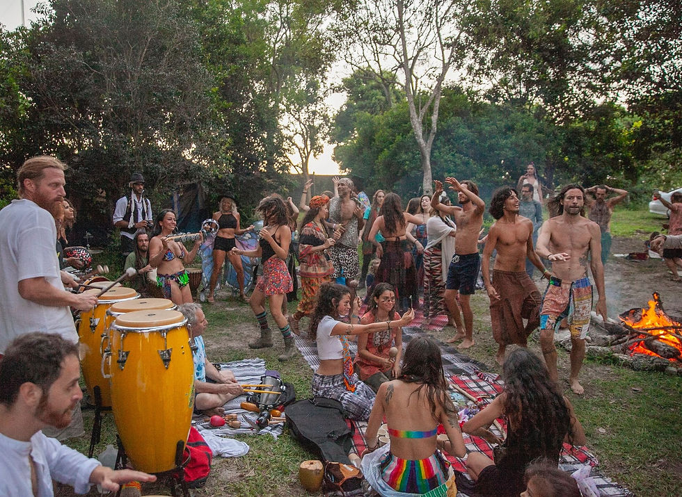 People dancing around a sacred fire in a natural oasis