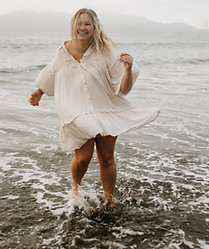 photo of documentary-style photographer Morgan Reed dancing in the water in san francisco for a branding photo shooot