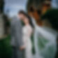 A bride & groom in a romantic forhead to forhead pose, bodies pressed tightly together, at wedding venue Westenhanger Castle, Kent. The wind is blowing the brides veil. Image by Moment Weddings Film & Photography.