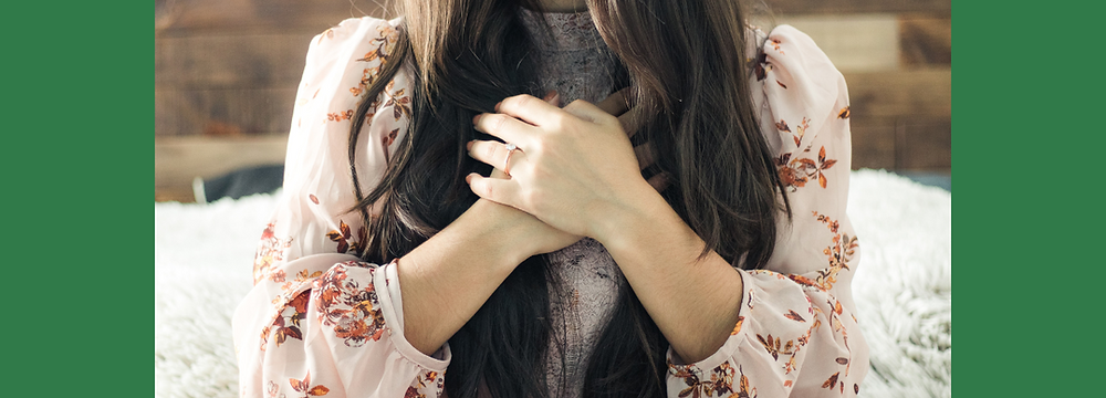 Woman with hands on heart