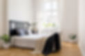 knit-blanket-on-bed-in-minimal-white-bedroom-inter-2021-08-26-15-45-35-utc.jpg