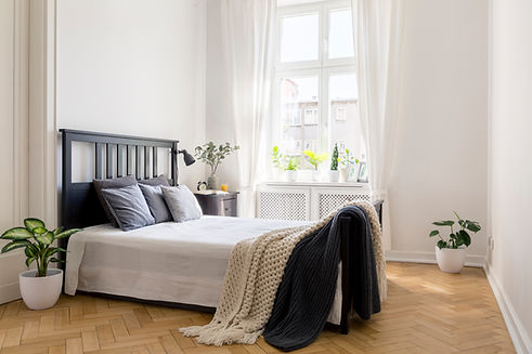 knit-blanket-on-bed-in-minimal-white-bedroom-inter-2021-08-26-15-45-35-utc.jpg
