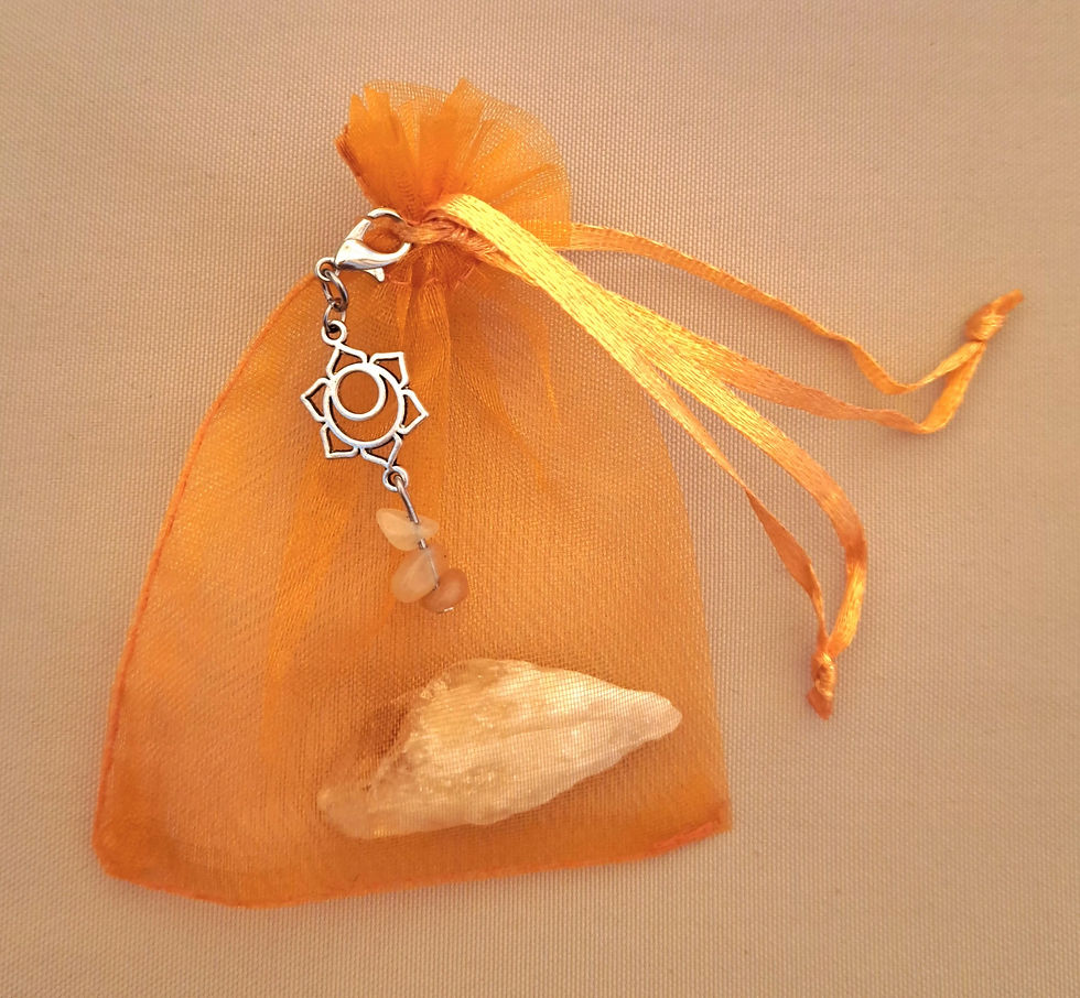Thumbnail: Sacral Chakra meditation accessories Orange organza bag with ribbon tie, crystal and chakra charm. www.astralthreads.co.uk