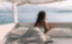 shirtless-woman-lying-bed-against-sea.jpg