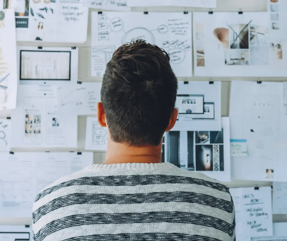 Man looking at ideas on bulletin board