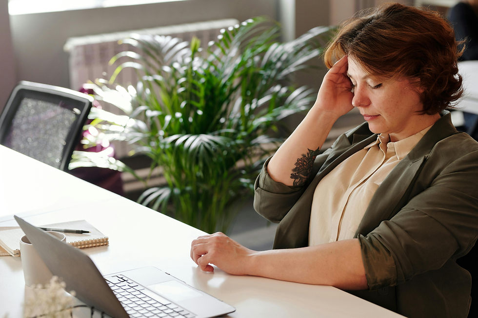 Lady at work feeling tired sat at a desk