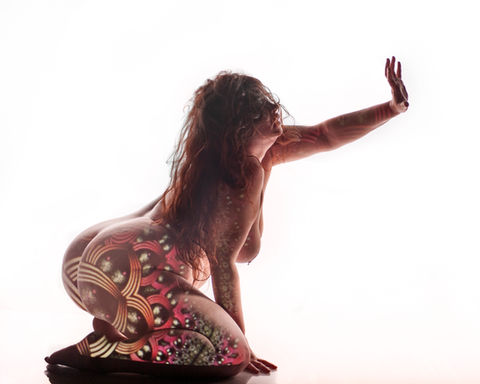 Fine art photograph of the nude female form with layered projected imagery.