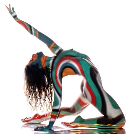 Art nude photograph of the female form with expressive projected light patterns.