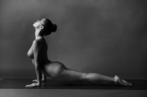 Nude figure in meditative yoga pose with diffused light