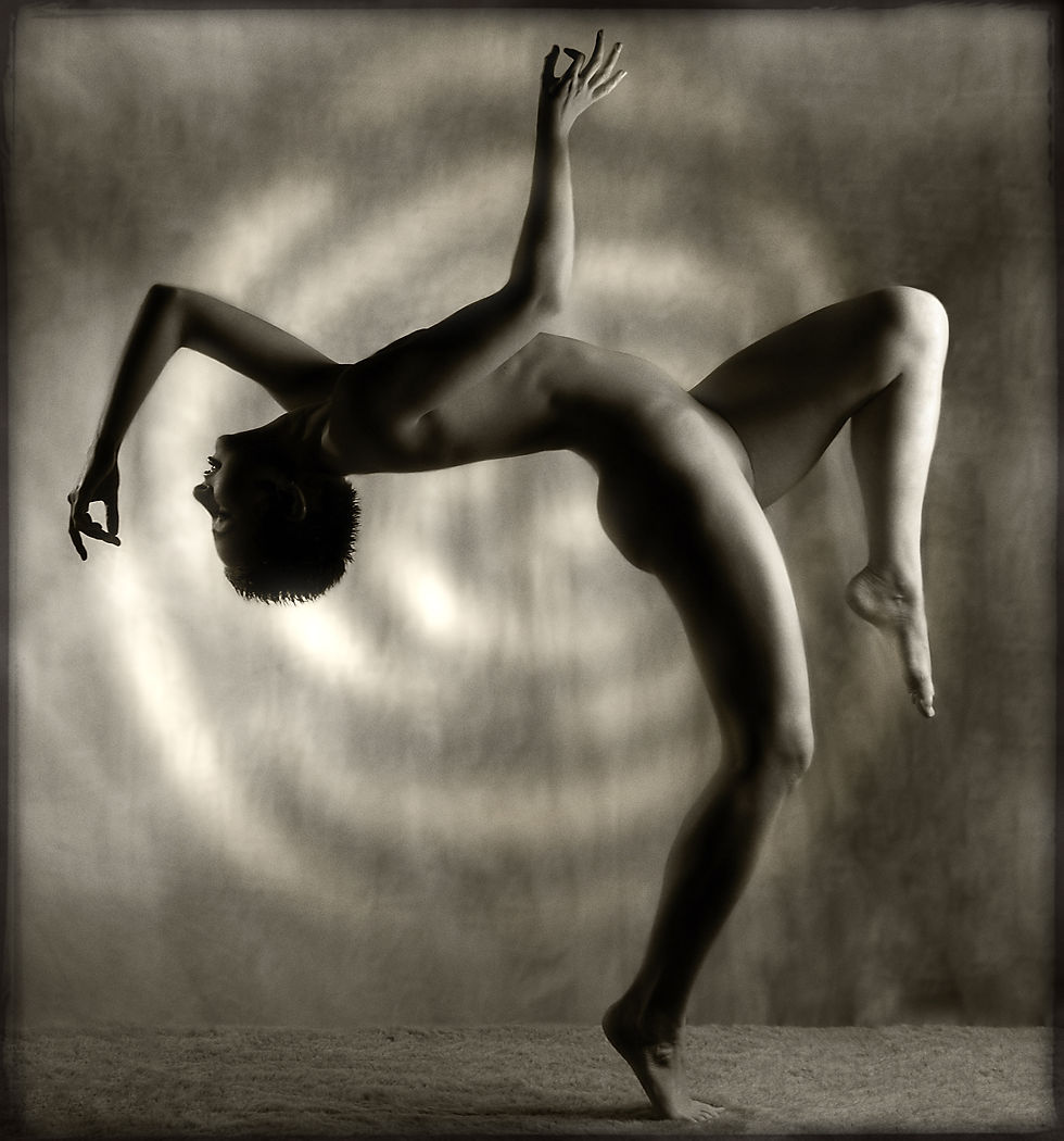 Dramatic image of nude woman in backbend