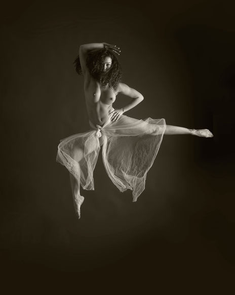 Artistic nude dance composition focusing on negative space, clean lines, and dynamic body movement.
