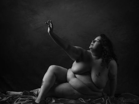 Fine art nude photograph of a plus sized model in black and white.