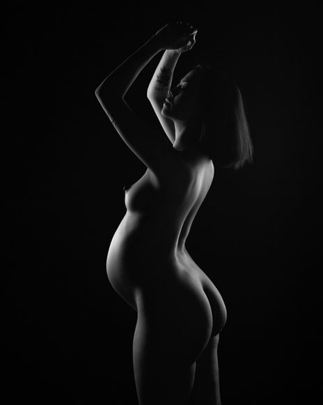 Chiaroscuro lit maternity photograph