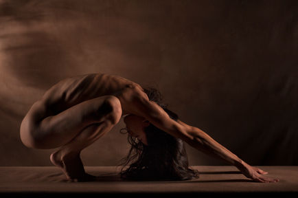 Fine art nude yoga pose emphasizing balance and calm