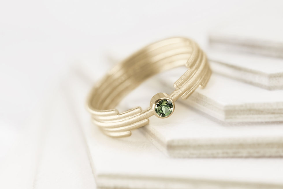 Close-up view of a minimal art-deco inspired engagement ring with a single gemstone