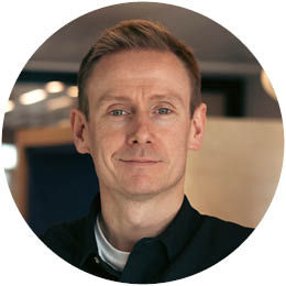 A person smiling slightly, Flood Platform team member.