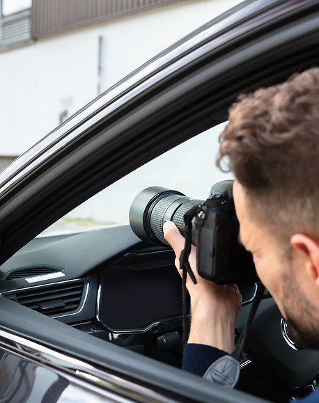 Private Detective Taking Photos Of Man And Woman On Street.jpg