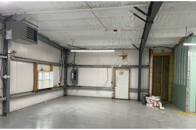 The kitchen before the renovation, showing outdated equiment and dim lighting.