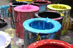 multi colored paints in buckets