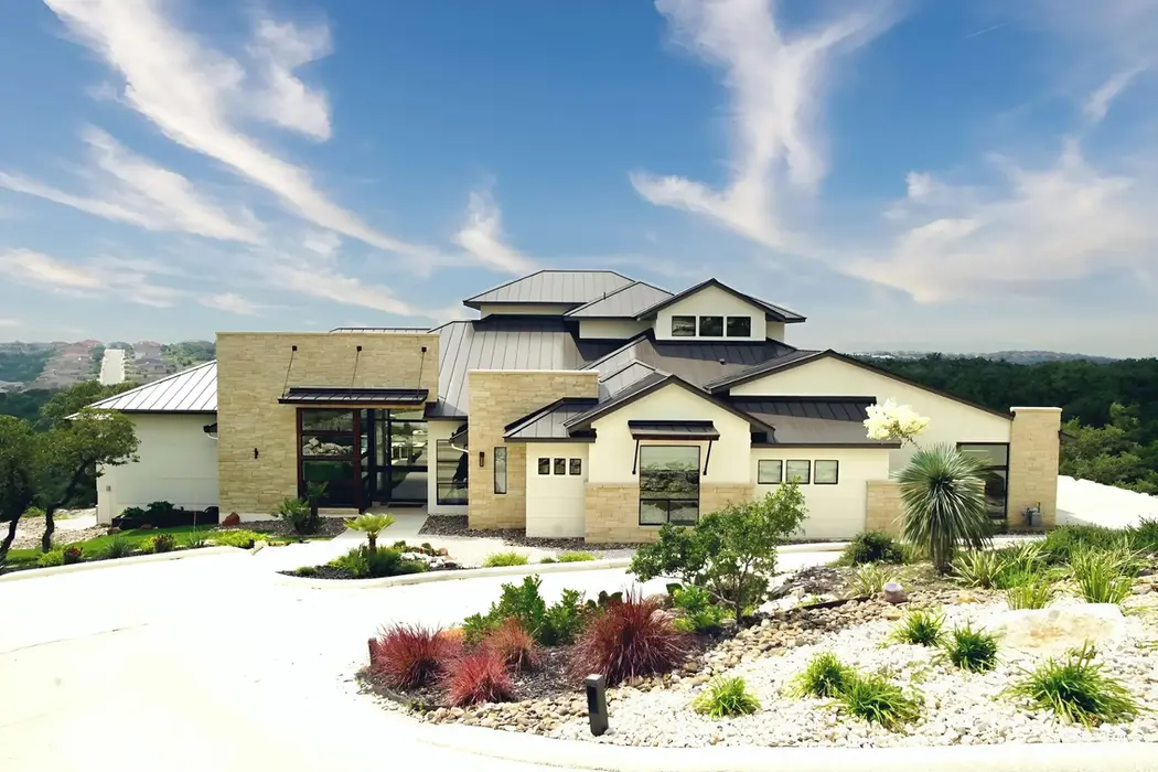 Custom Home with black metal roof located in Comfort Texas.