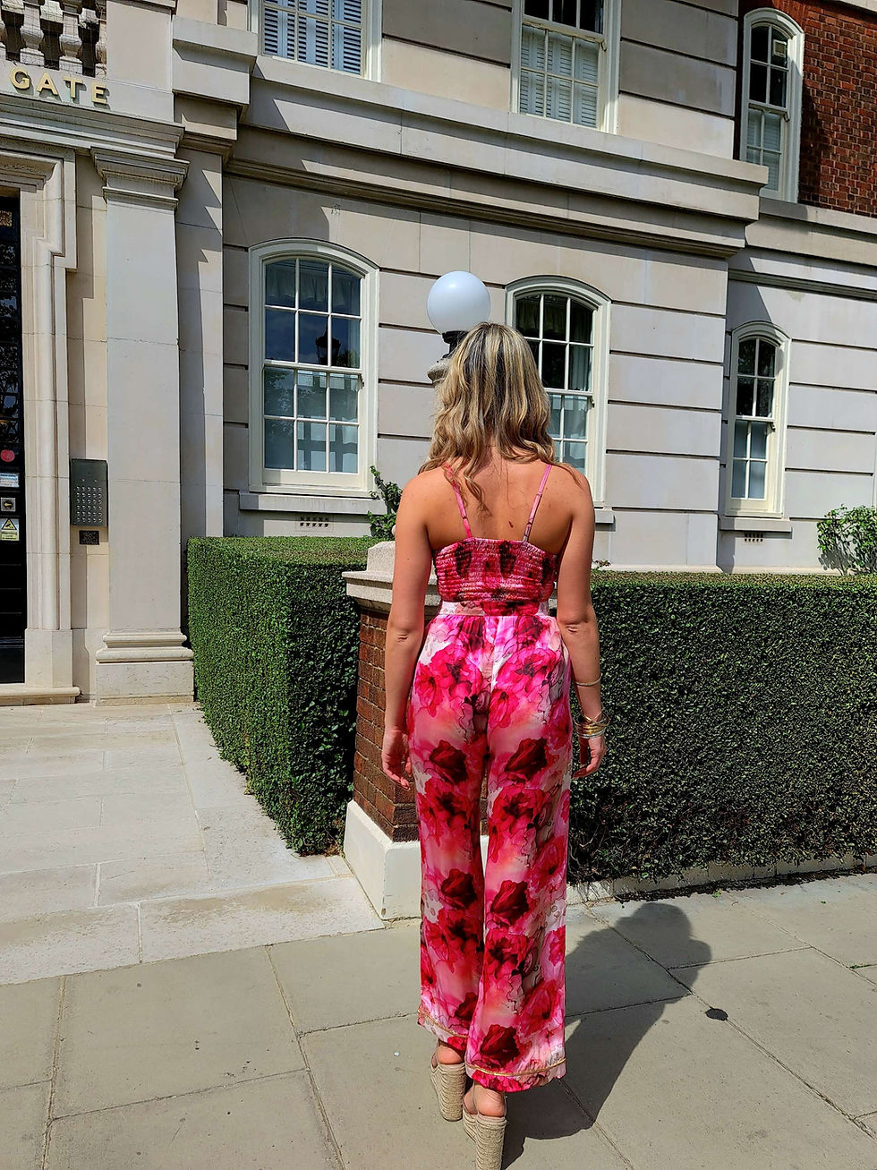 Thumbnail: Female wearing bralette and trousers all in same print. Back view