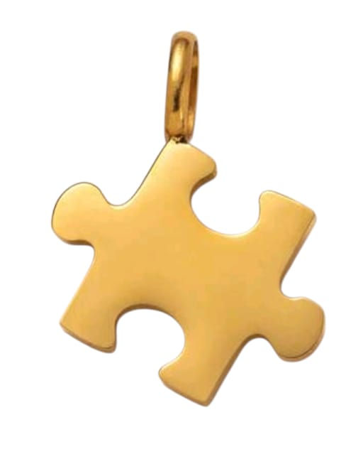 Shiny gold puzzle piece charm hanging on a small loop.