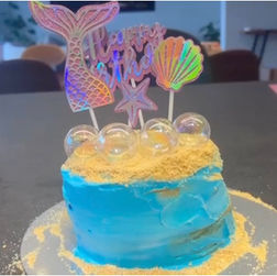 In this picture a blue cake decorated with see elements.