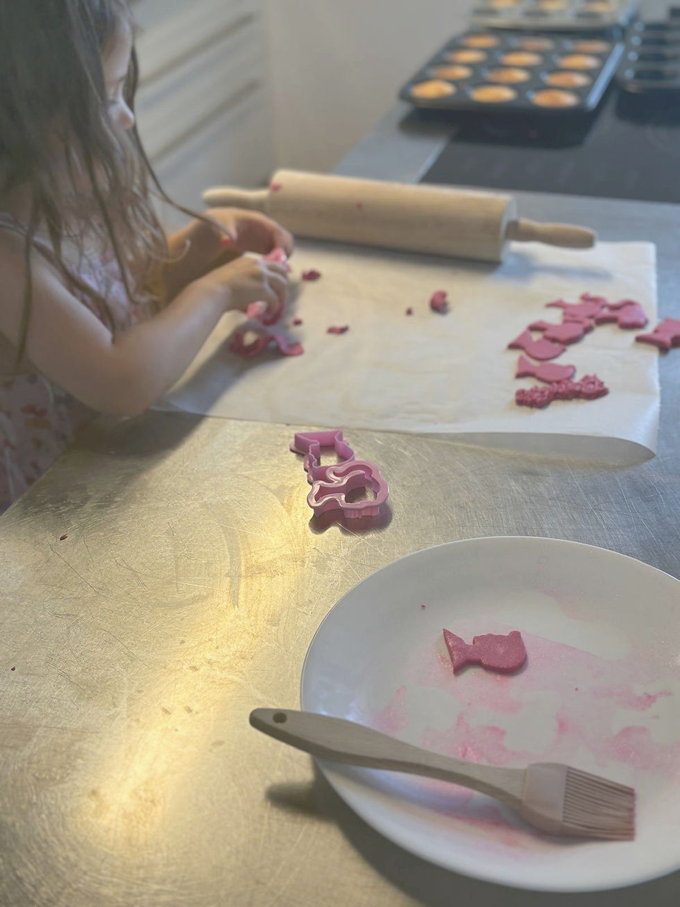 A young girl decorating using a Barbie cupcakes kit