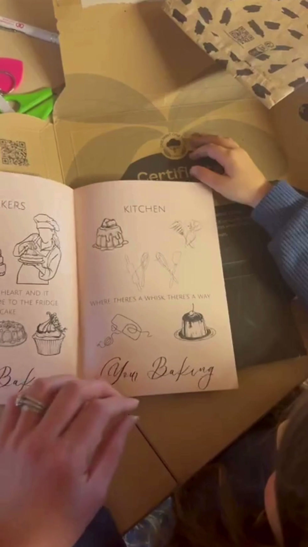 Thumbnail: Video of a child flipping through the Cake It Yourself coloring booklet pages with baking illustrations