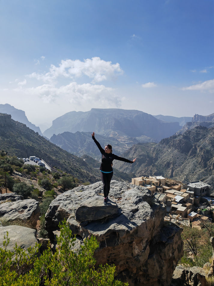 Hiker enjoying panoramic views of the Hajar Mountains during a Jabal Akhdar day excursion