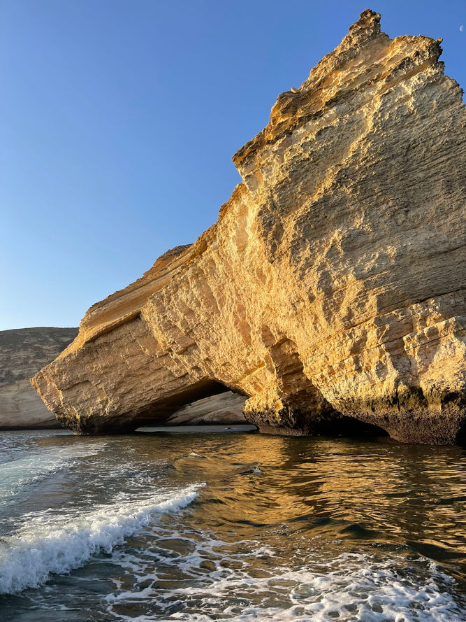 Dramatic limestone sea cliff on the Bandar Khairan coast during a private boat tour in Oman