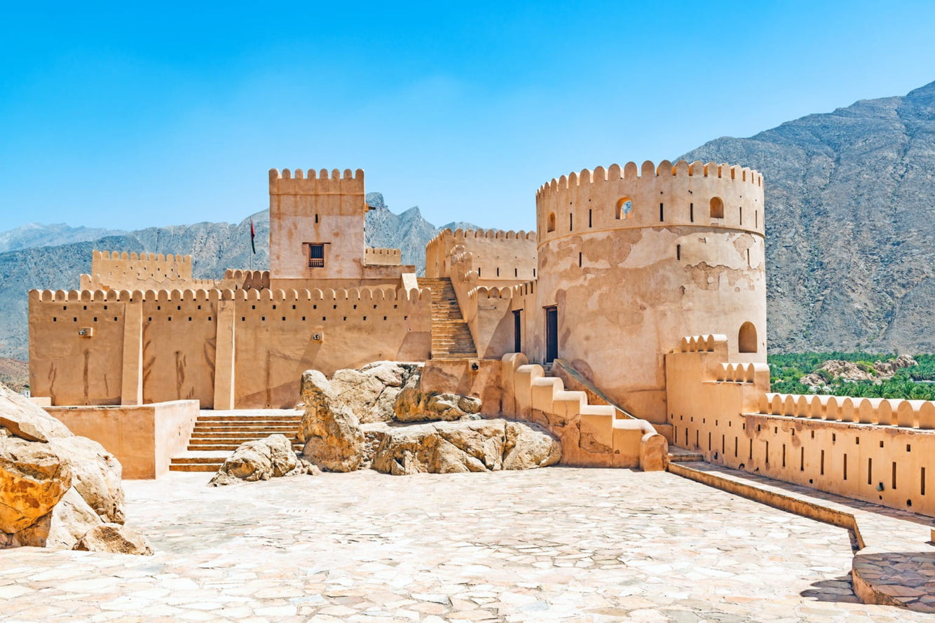 Historic Nakhal Fort beneath the Hajar Mountains on a cultural excursion from Muscat