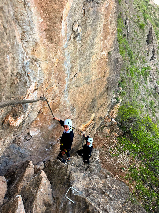 Traveler exploring a rocky mountain gorge in Dhofar, Oman
