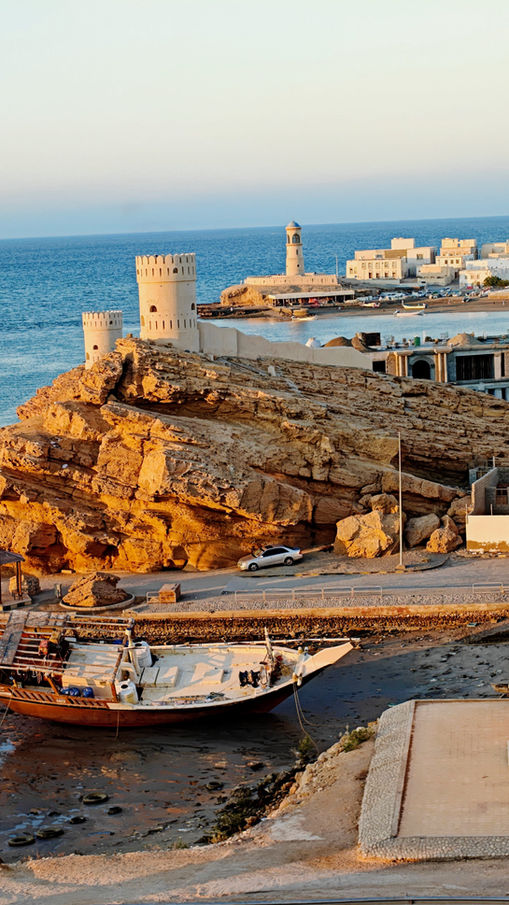 Historic coastal fort overlooking the sea and harbor in Oman
