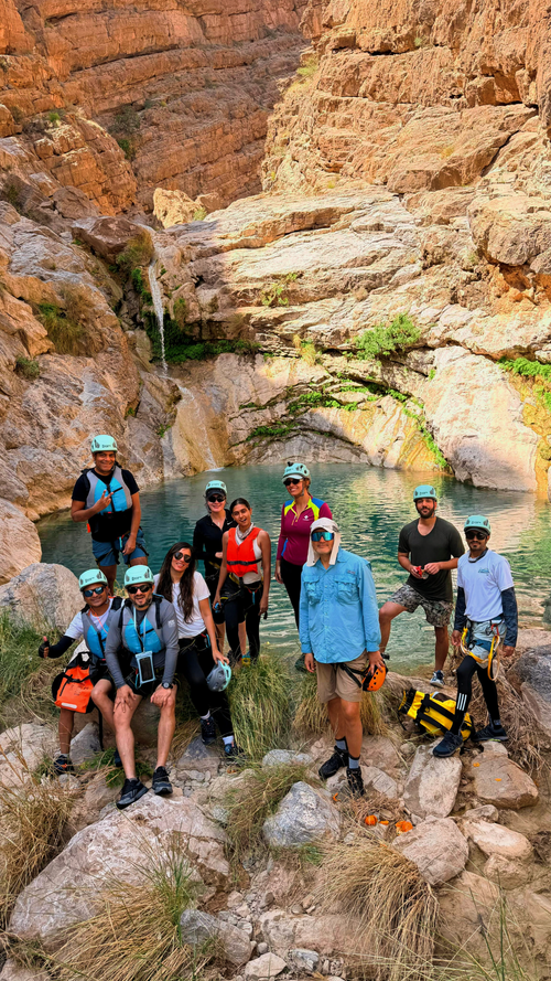 Guided hiking group inside Wadi Kamah on a one-day adventure tour in Oman