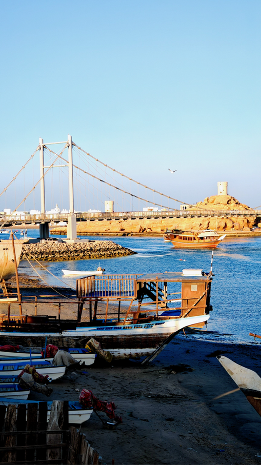 Traditional wooden dhow boats in the harbor of Sur