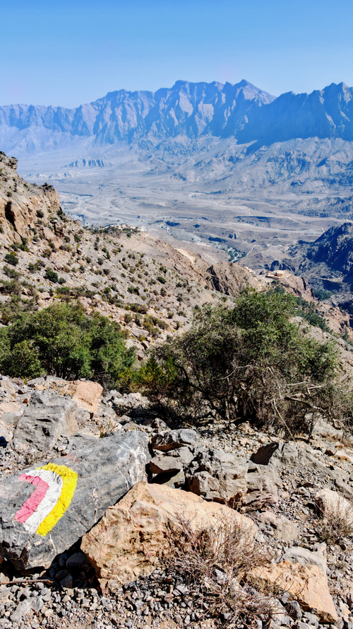 Hiker enjoying mountain views on the Wakan Village walking tour