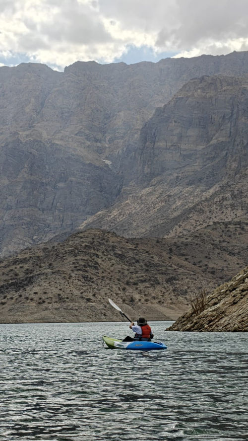 Kayaking through the dramatic mountain landscape of Wadi Dayqah Reservoir in Oman
