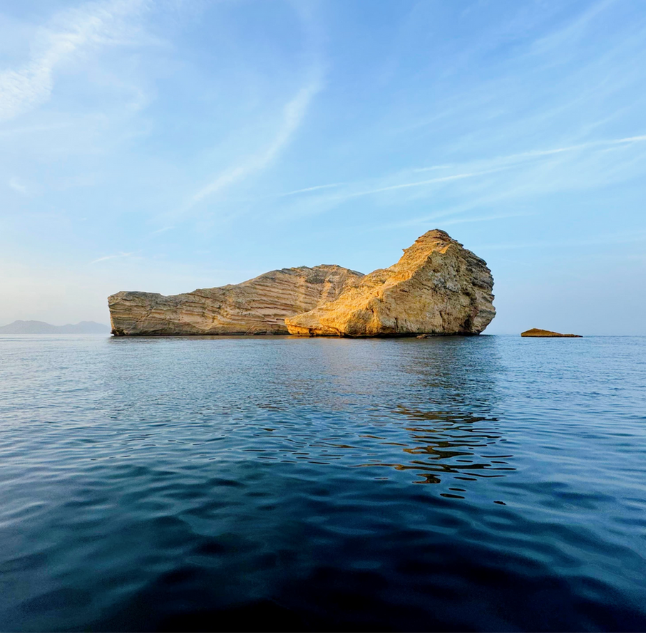 Al Fahal Island rising from the sea on a boat trip near Muscat, Oman