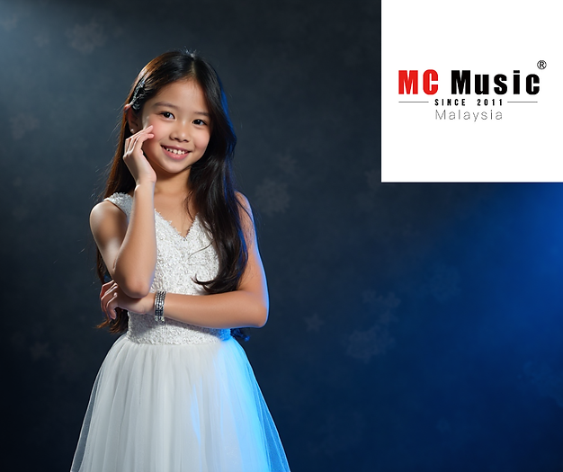Girl in white dress smiling, hand on cheek, against a dark, softly lit background. MC Music Malaysia logo in corner.